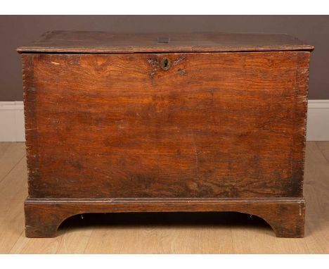 An 18th century and later elm box or trunk with moulded decoration to the top, chip carved decoration down each side and stan