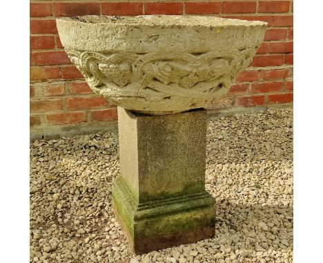 A cast reconstituted stone circular bowl shaped planter decorated with stylised vine foliage; together with a cast reconstitu