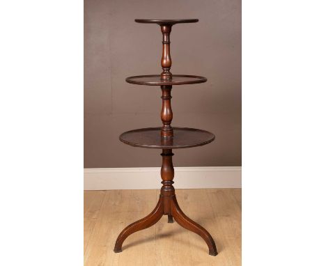 A 19th century mahogany three-tier dumb waiter with turned baluster supports and on a tripod base54cm diameter x 126cm highQt