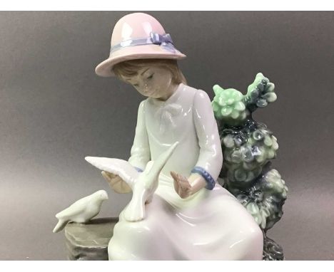 TWO NAO FIGURES comprising a seated girl with two doves and a girl in Communion dressthe first figure 22cm highQty: 2