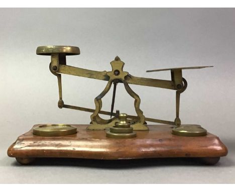 SET OF VICTORIAN POSTAL SCALES ALONG WITH AN OAK MANTEL CLOCK the scales in brass and wood, including some weights, the clock