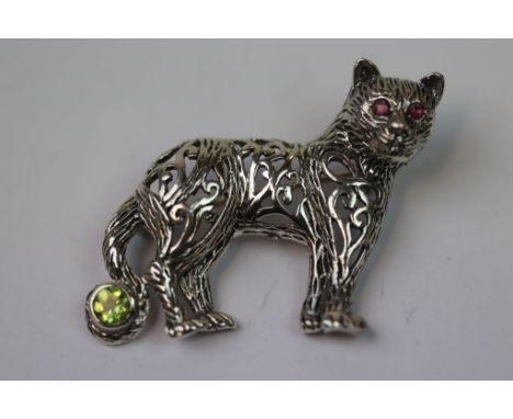 Silver and Plique-à-jour lioness brooch with ruby eyes and peridot tail 