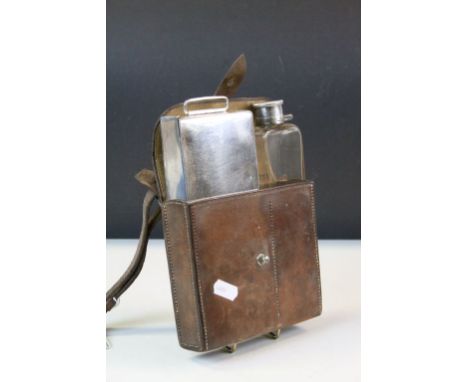 Leather case containing a silver plated sandwich box and a glass hip flask with silver plated lid 