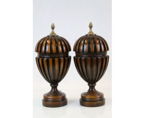 Pair of hard wood lidded urn shaped caskets with reeded decoration with brass fur cone finial's 