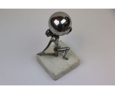 Art Deco chrome table lighter in the form of a women carrying a globe on her shoulders raised on a marble base 