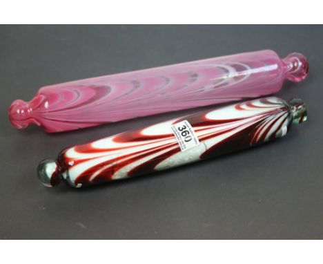 19th Century type rolling pin with pink swirls 40cm and another clear glass rolling pin with red swirls 36cms (2) 