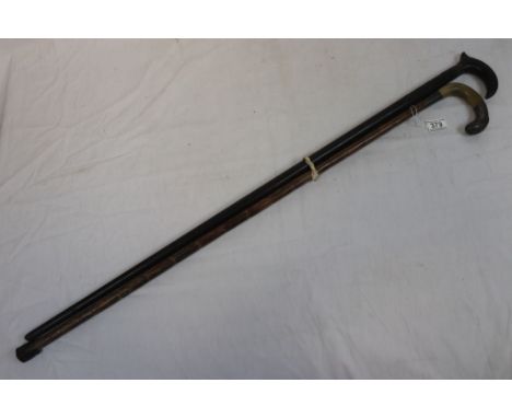 Ebonized walking stick with floral carving to stem and a horn handled walking stick with white metal mount 