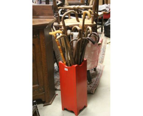 Red painted stick stand of square form, together with a quantity of vintage walking sticks and clubs etc 