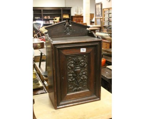 Victorian Oak Hanging Cupboard, the heavily carved single door opening to reveal a shelf, 60cms high x 37cms wide
