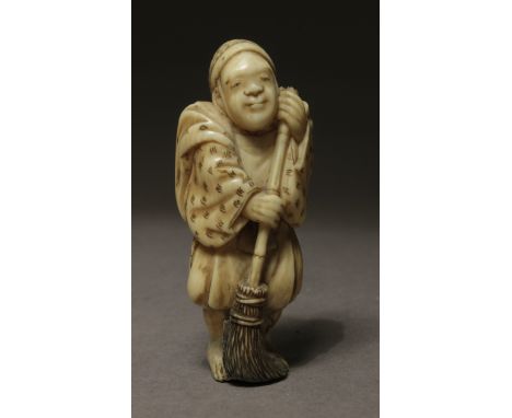 A mid 19th century netsuke from Edo period. Signed Tomonobu on the back. In carved elephant ivory portraying astanding Eji, s