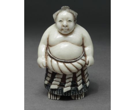 A late 19th century Japanese netsuke from Meiji period. Signed on the base. In carved elephant ivory portraying a sumo fighte