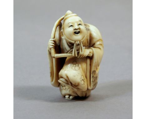 A 19th century Japanese netsuke from Meiji period. Not signed. In carved elephant ivory portraying Saizo, one of the Manzai d