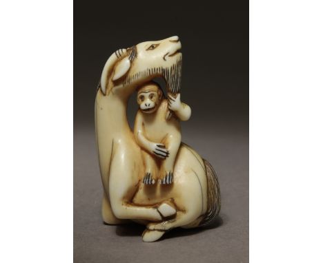 An 18th century Japanese netsuke from Edo period. Not signed. In carved elephant ivory portraying a sat 'Siniu' with its head