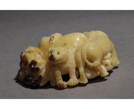 An early 20th century japanese netsuke from Meiji period. Signed Toyuyuki on the base. In carved hornbill portraying a group 