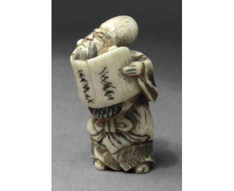 A 19th century Japanese netsuke from Edo period. Not signed. In carved horn portraying a standing Fukurokuju holding a scroll