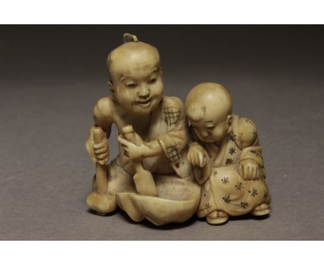 A late 19th century Japanese netsuke from Meiji period. Not signed. In carved ivory portraying a mask sculpteur sat on the fl