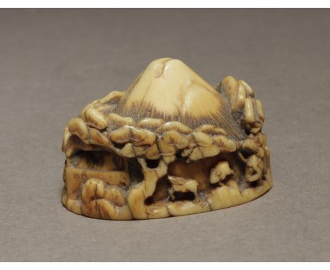 A late 19th century Japanese netsuke from Meiji period. Signed on the base with a kakihan. In carved ivory portraying a sculp