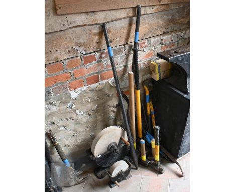 Assorted used hand tools including crow/pry bars, club and sledgehammers, two grinding/sharpening wheels, etc
