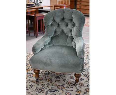 A Victorian nursing chair upholstered with green button back fabric 