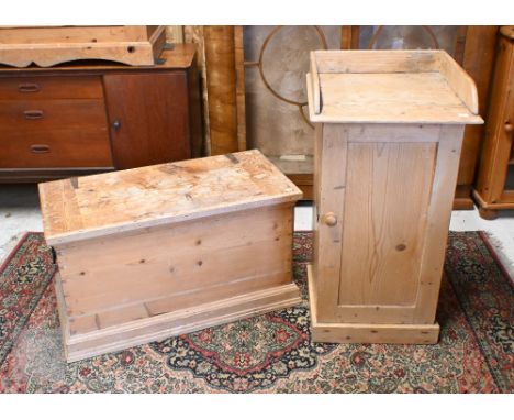 A vintage pine bedside cabinet with panelled door, 44 x 44 x 84 cm high to/w a pine trunk, 80 x 40 x 45 cm high (2)