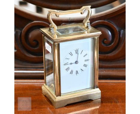 A French brass carriage clock with enamel dial, 15 cm high