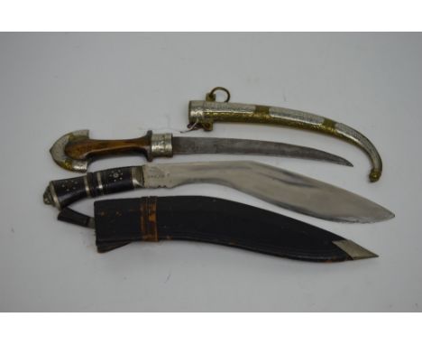 A mid-20th century kukri knife in leather scabbard and a further 20th century Eastern knife with wooden handle with brass and