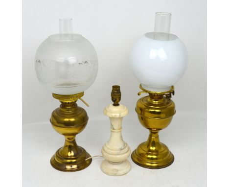 A duplex brass oil lamp, a brass oil lamp converted to electricity and a table lamp (3).