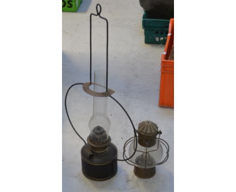 An Edwardian metal adjustable standard lamp with octagonal clear glass shade and two vintage metal oil lamps (3).