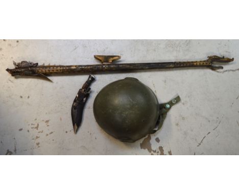 A miniature Kukri knife, a 20th century combat helmet and a 20th century bone-mounted tribal artifact (3).