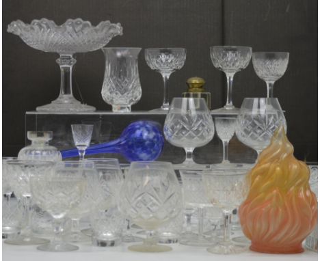 A large quantity of cut glass and crystal to include wine glasses, brandy glasses and a large cake stand with cover.