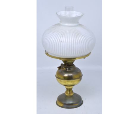 A Duplex brass oil lamp with opaque fluted white shade, height 50cm.