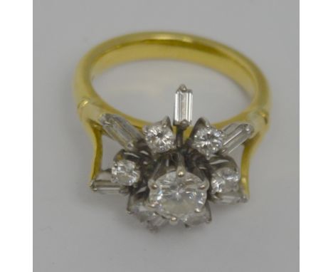 An 18ct yellow and white gold floral design ring set with central brilliant cut diamond (approx 0.7ct) surrounded by twelve f