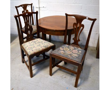 A pair of Edwardian oak dining chairs with carved centre rail and tapestry seats, a further similar chair and an early 20th c