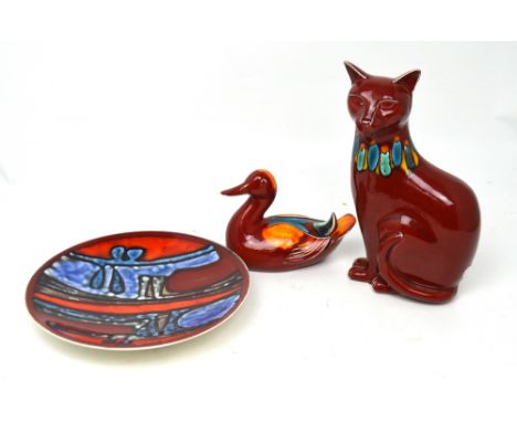 Three pieces of Poole to include a Delphis cat, height 29cm, a duck and a decorative wall plate (3).   CONDITION REPORT  Some
