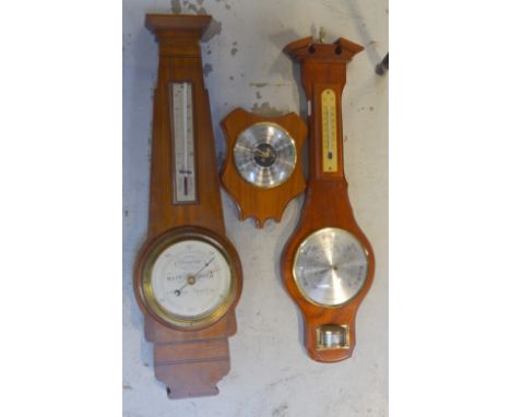 A walnut wall barometer by Short & Mason of London, height 61cm, a smaller modern wall barometer and a further example (3).