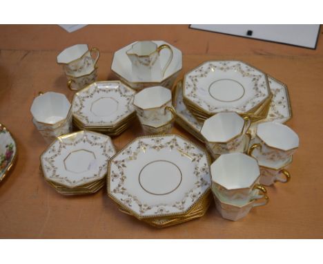 A Wedgwood late 19th century part tea service, white and gilt-heightened with floral and swag decoration, to include twelve c