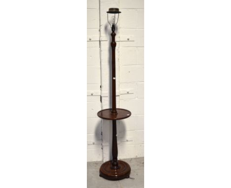 An early 20th century mahogany standard lamp, turned column with circular base raised on three half-bun feet, height approx 1