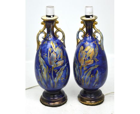 A pair of ceramic blue ground baluster twin-handled lamp stands with Oriental style silk shades, height of lamp 38cm. (2). 
