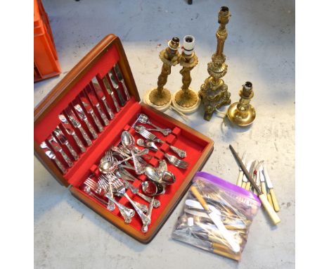 A quantity of silver plated flatware, a canteen of cutlery, three gilt metal table lamps and a brass table lamp modelled as a