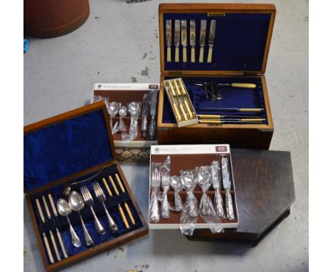 A quantity of silver plated flatware, part-contained within three canteens.