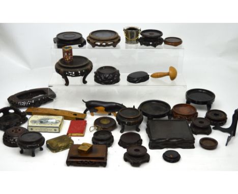 A quantity of Oriental hardwood and ceramic stands, a wooden darning tool, a small cloisonné pot, a vintage leather-cased tap
