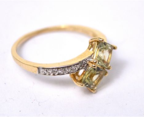 A 9ct yellow gold dress ring set with two citrine stones and diamond chips to the shoulders, size P, approx 2.3g.