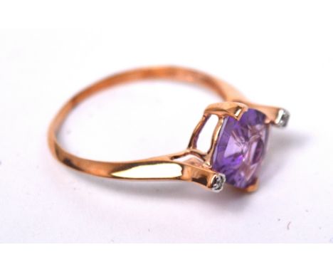 A 9ct rose gold contemporary dress ring by Glen Lehrer set with central quasar cut amethyst flanked by diamond chips, with ce