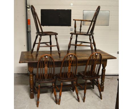 An oak refectory style table, cleated plank top above turned legs, block supports and conjoining stretcher, width 188cm and a