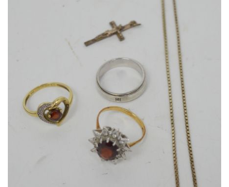 Two 9ct gold dress rings, one with central floral set red stone, surrounded by white stones, the other heart-shaped with cent