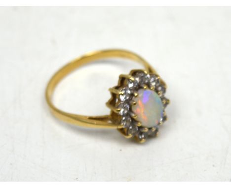 A yellow gold opal and white stone set ring, size R, approx 2.7g.