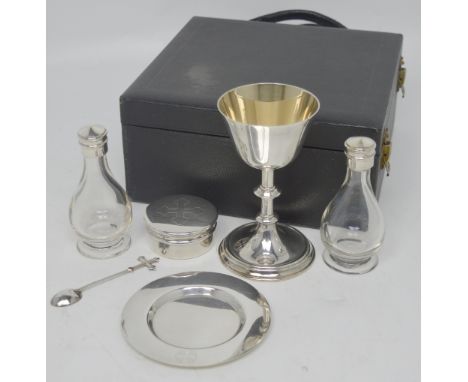 An Elizabeth II cased hallmarked silver Holy Communion set, A R Mowbray & Co Ltd, London 1958, to include a wafer box, a pate