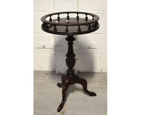 A reproduction mahogany tripod wine table, galleried and raised on a turned pedestal, diameter 40cm.