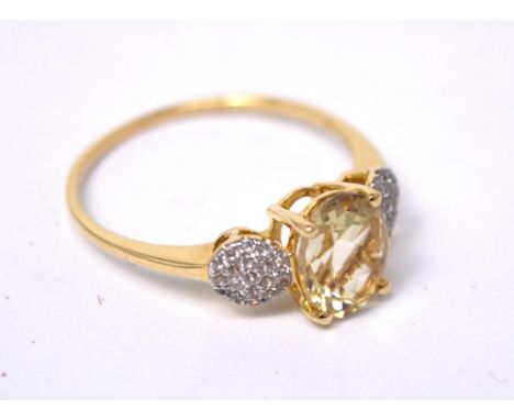 A 9ct yellow gold dress ring set with a central citrine-ype stone and diamond shoulders, size R, approx 2g.