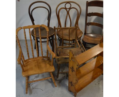 A farmhouse style ladder back rocking chair, two bentwood chairs, a pine children's stick back rocking chair, a high chair an
